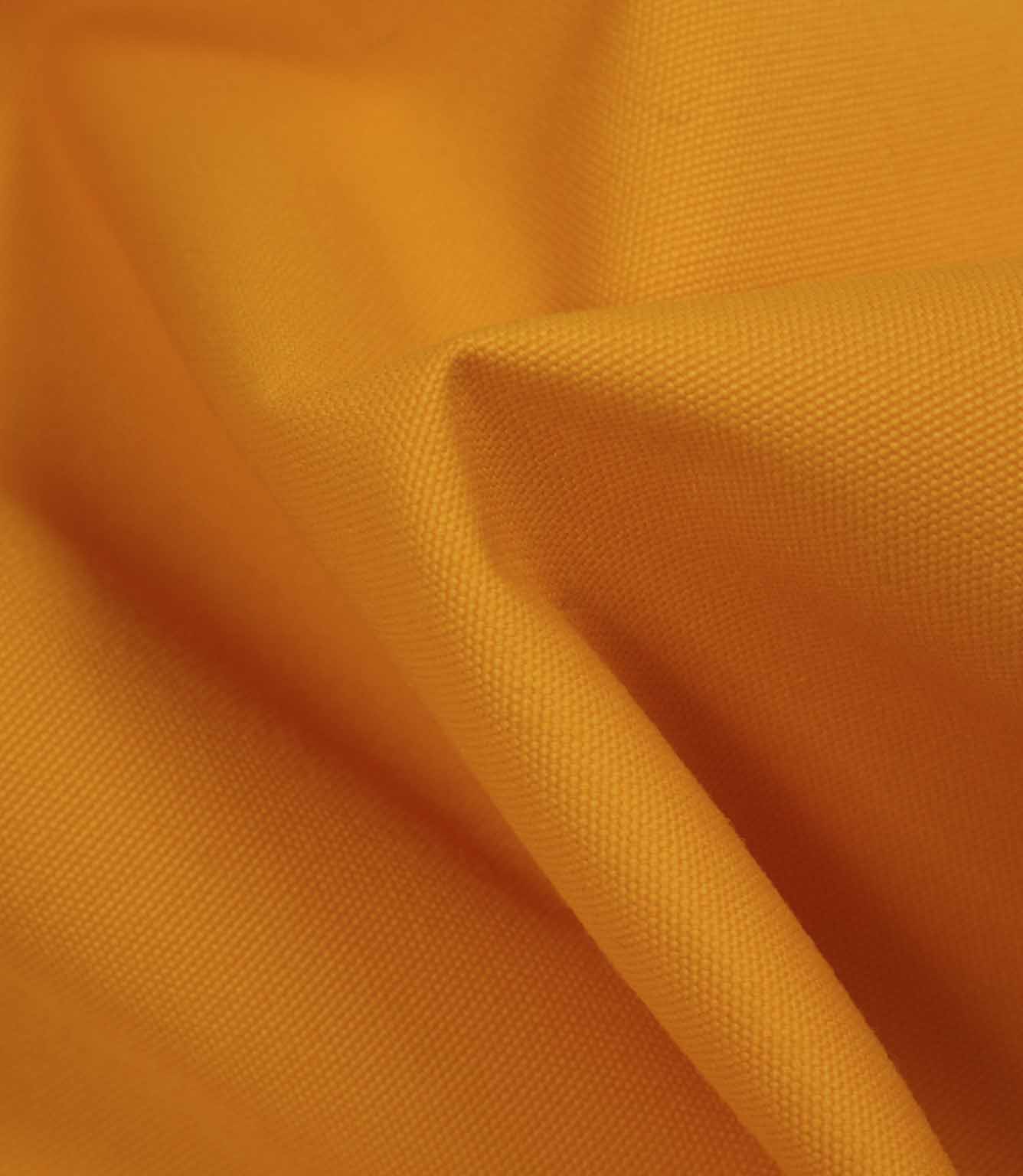 Softly draped orange fabric highlighting flexibility, texture, and light surface sheen.