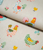 	Folded Cottage Hens Multi fabric displaying playful chicken and chick illustrations with colourful patterned feathers and scattered flowers.