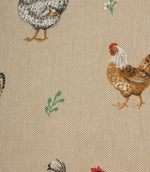 Close-up of rustic chicken print fabric with brown and black hens, soft green leaf motifs and a natural linen-look background.