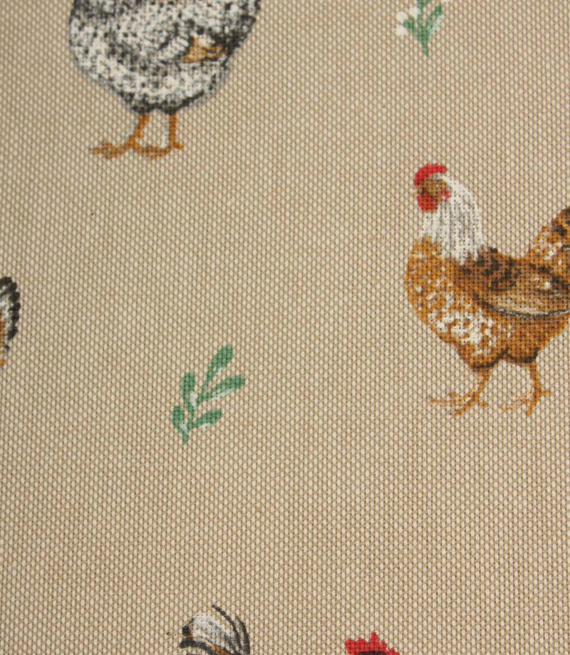 Close-up of rustic chicken print fabric with brown and black hens, soft green leaf motifs and a natural linen-look background.