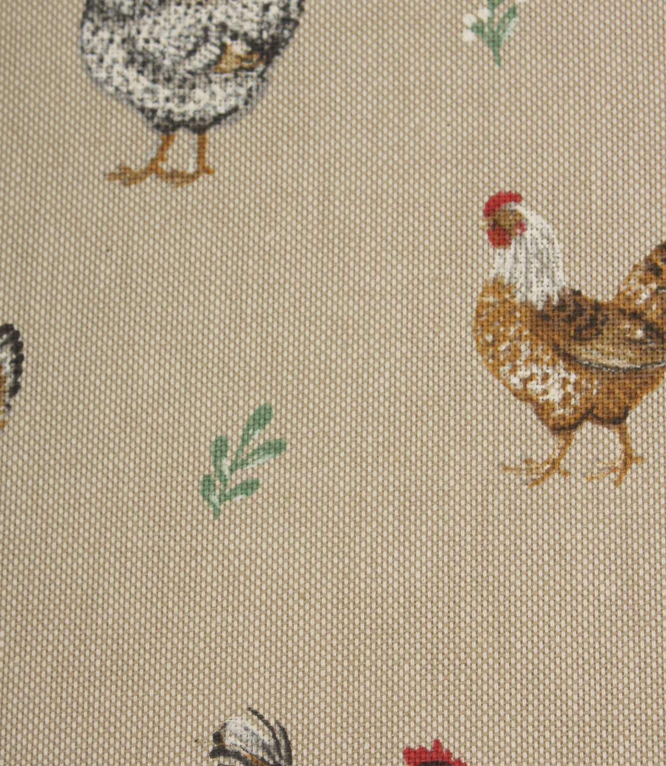 Close-up of rustic chicken print fabric with brown and black hens, soft green leaf motifs and a natural linen-look background.