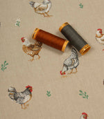 Farmhouse-inspired fabric with illustrated chickens on a neutral beige base, shown with coordinating rust and charcoal thread spools.