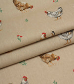 Folded country print fabric featuring scattered hens and tiny floral details on a warm natural background.