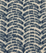 Outdoor upholstery fabric featuring layered navy and denim blue botanical wave motifs on a cream base.