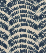 Close-up of coastal patterned outdoor fabric with deep blue abstract foliage design in a repeating curved layout on ivory fabric.