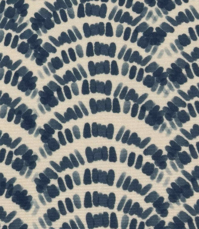Close-up of coastal patterned outdoor fabric with deep blue abstract foliage design in a repeating curved layout on ivory fabric.
