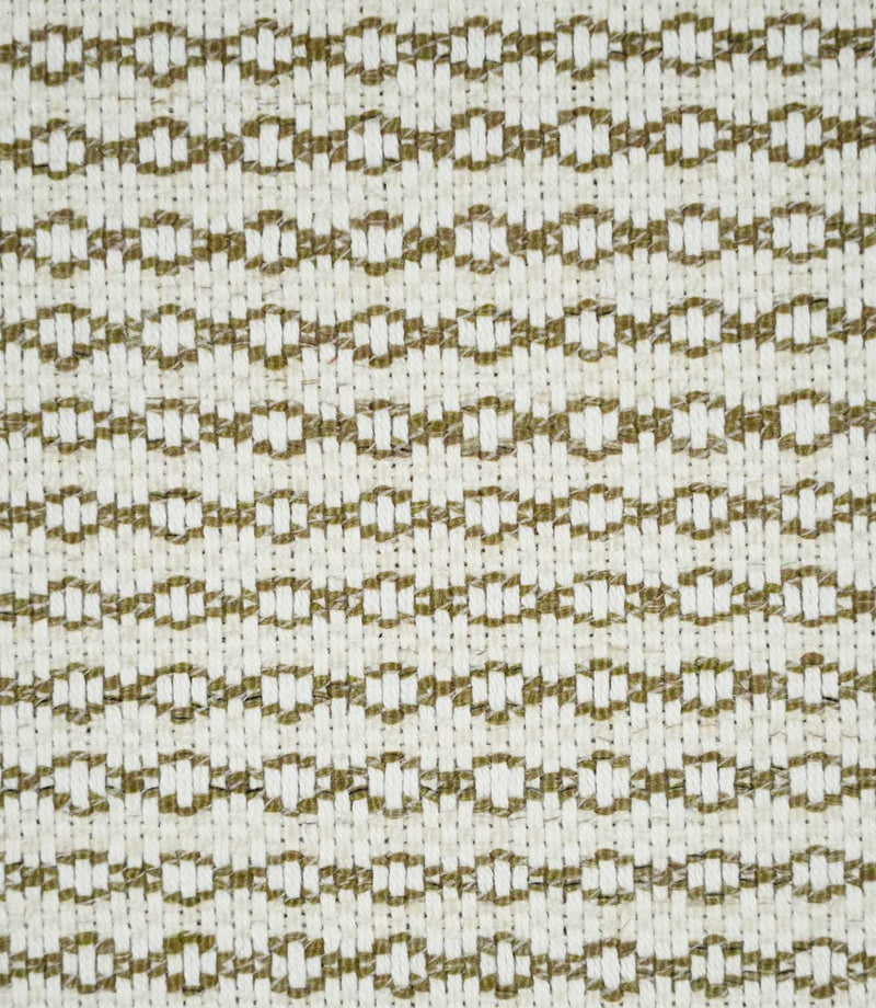 Close-up of Elkstone Matcha upholstery fabric featuring a textured cream weave with repeating olive green geometric motifs arranged in narrow horizontal rows.