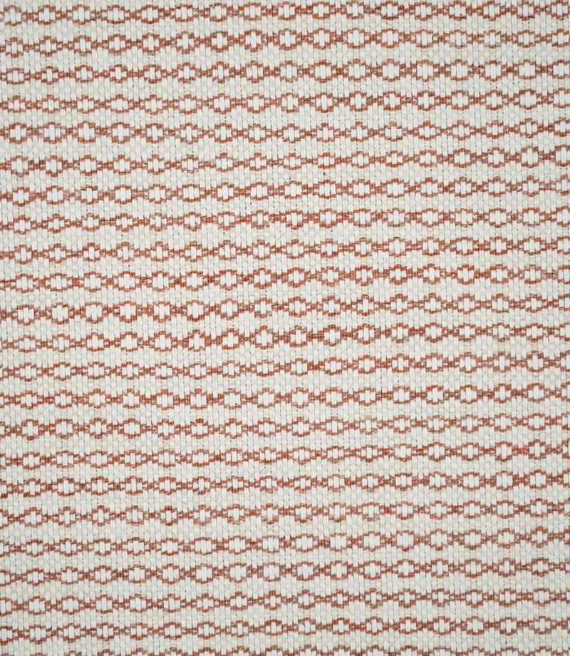 Full view of Elkstone Terracotta woven fabric showing a small-scale geometric pattern of repeating rust-orange linked shapes across a natural cream background.