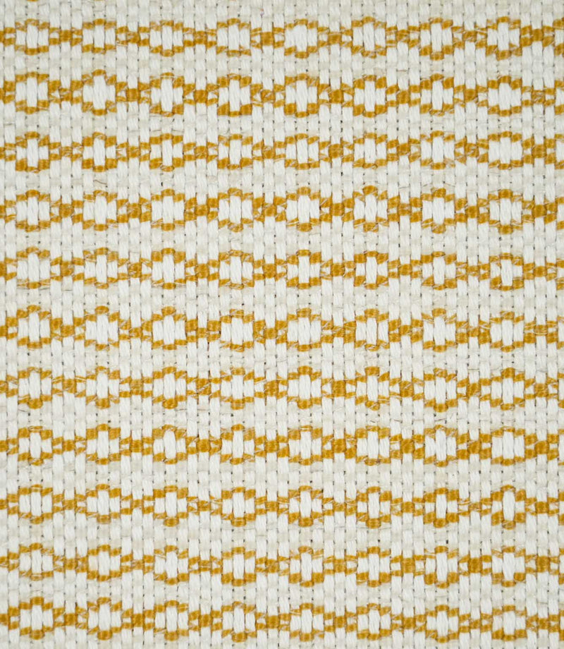Close-up of Elkstone Turmeric fabric featuring a textured natural cream weave with repeating golden mustard geometric motifs arranged in horizontal rows.