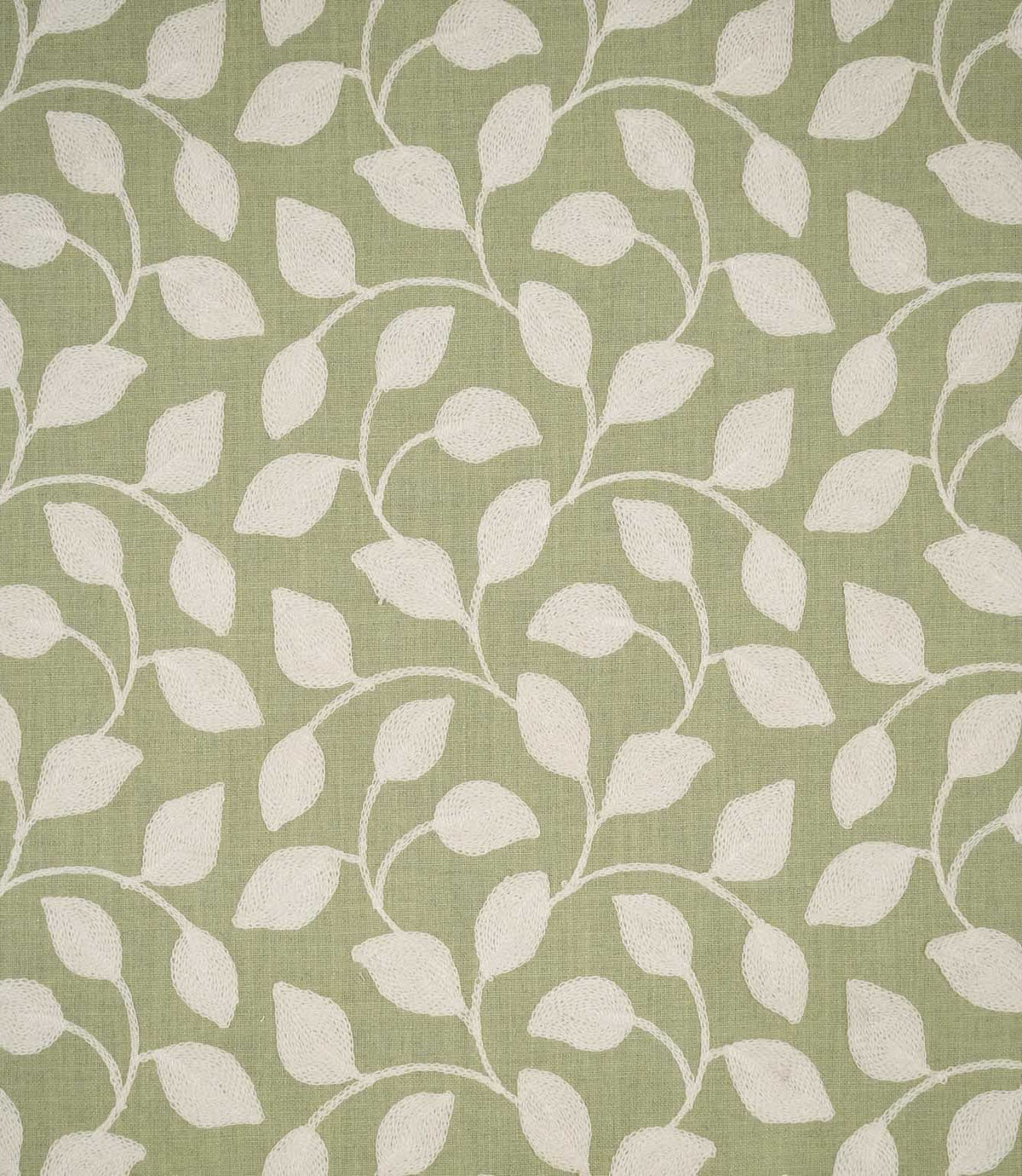 Ellerton Apple embroidered fabric featuring a flowing cream foliage design with softly curved stems and rounded leaves across a fresh apple green woven background, shown flat to clearly display the repeating contemporary botanical pattern.