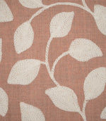 Detailed close-up of Ellerton Blush fabric showing raised cream embroidered leaves and delicate winding stems against a blush pink woven ground, highlighting the individual stitches, subtle fabric weave and tactile texture of the botanical design.