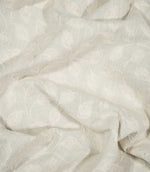 Ellerton Cloud embroidered fabric loosely draped into natural folds, featuring a repeating ivory leaf and flowing vine design on a pale cloud-grey woven ground, demonstrating the fabric's soft movement, botanical pattern and textured embroidered surface.