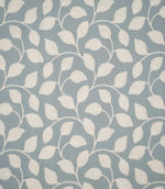 Ellerton Cornflower embroidered fabric featuring a flowing cream foliage design of softly curved stems and leaves across a muted cornflower blue woven background, shown flat to clearly display the repeating botanical pattern.
