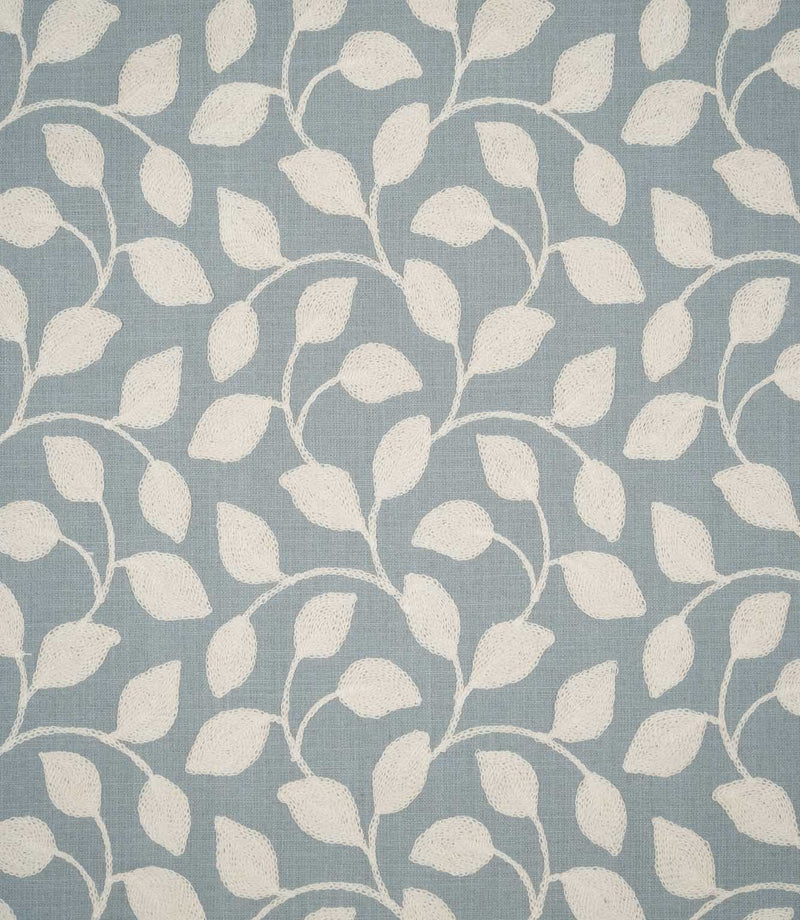 Ellerton Cornflower embroidered fabric featuring a flowing cream foliage design of softly curved stems and leaves across a muted cornflower blue woven background, shown flat to clearly display the repeating botanical pattern.