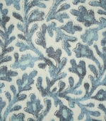 Close-up of Elmsley blue fabric showing the detailed floral and foliage print in layered blue, aqua and navy shades against a cream background.