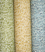 Three Elmsley floral fabrics displayed side by side in green, ochre and blue colourways, each featuring the same small-scale flowing foliage and stylised floral pattern on a soft off-white ground.