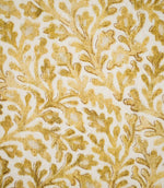 Detailed close-up of Elmsley Ochre fabric showing the hand-rendered character of the small-scale floral and foliage design, with softly mottled ochre leaves, delicate darker outlines and branching botanical forms on an off-white background.