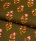 Olive green cotton fabric folded to show the drape and repeating floral block print design.