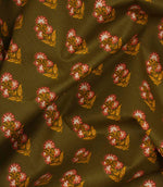 Draped olive botanical fabric with small pink and cream flower motifs and ochre leaf detailing.