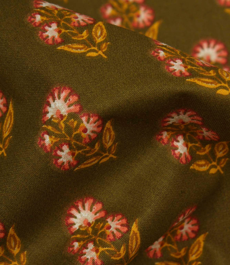 Close-up of olive floral fabric showing the textured weave and delicate repeating botanical pattern.