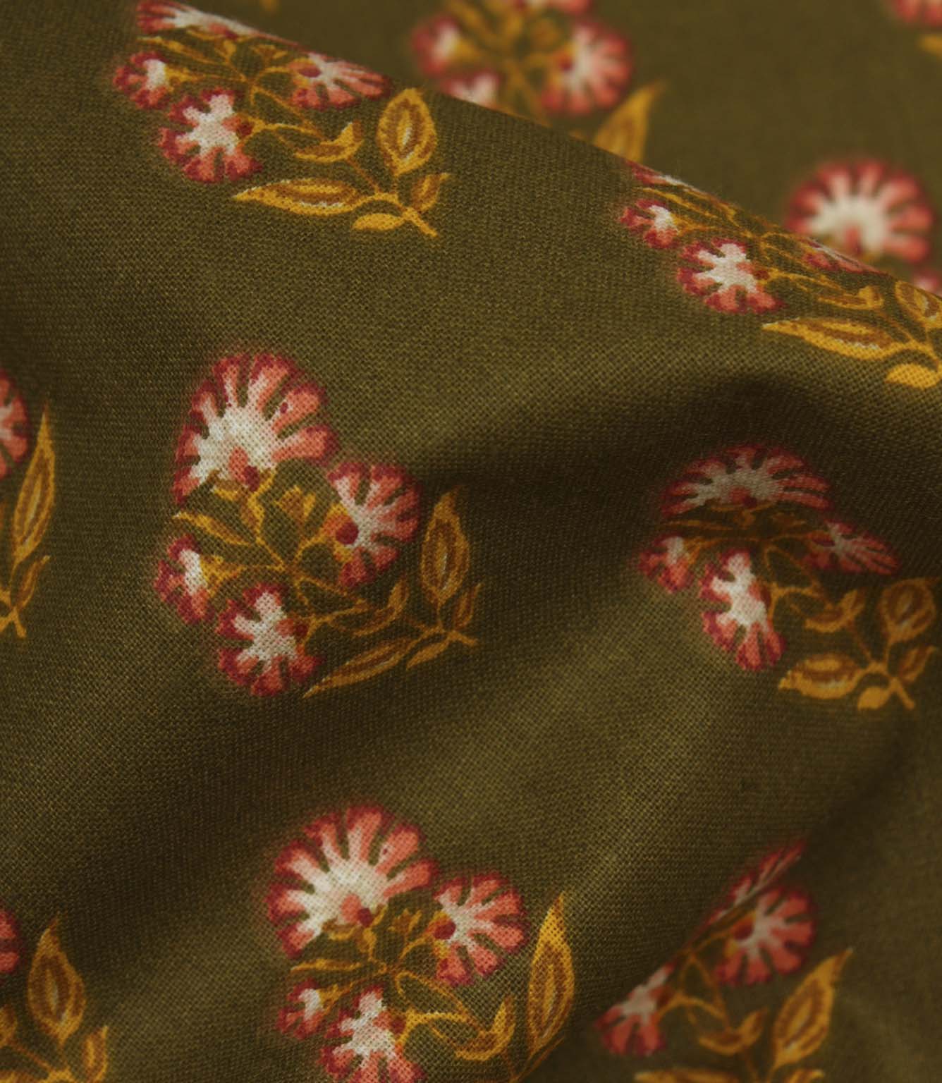Close-up of olive floral fabric showing the textured weave and delicate repeating botanical pattern.