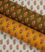 Coordinating botanical fabrics in soft ivory, warm ochre, and olive tones, each printed with small pink floral sprigs in a neat repeating pattern.