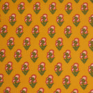 Mustard yellow fabric featuring a repeating floral sprig pattern with pink and white blooms and green foliage.