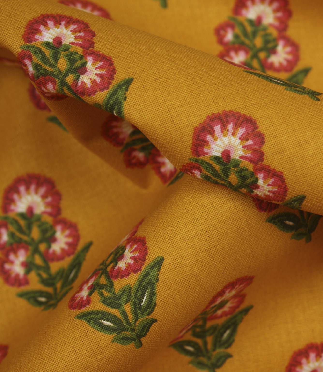 Close-up detail of mustard floral fabric highlighting the woven texture and stylised botanical print.