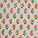 Delicate floral print fabric featuring small pink and orange blooms with green foliage on a soft ivory background.