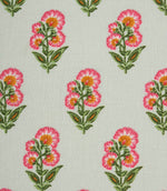 Close-up of ditsy floral fabric with stylised pink flowers and leafy green stems on a light neutral base.