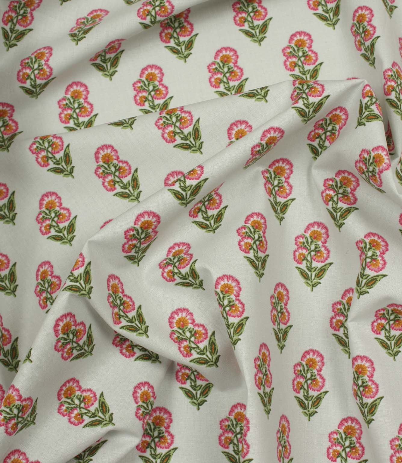 Draped botanical fabric featuring scattered pink floral sprigs in a neat repeating pattern on an ivory base.
