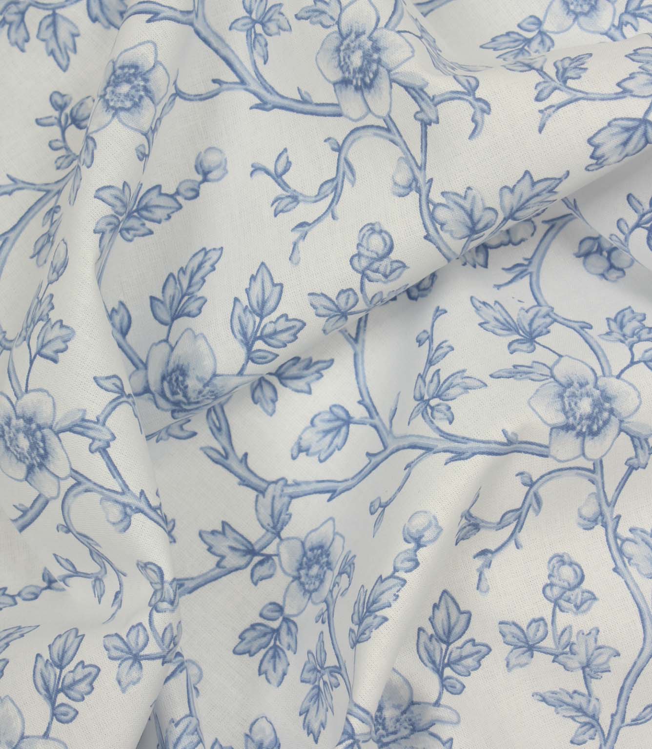 Draped blue and ivory floral fabric with flowing trailing stems and soft botanical motifs.