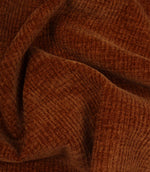 Draped Everleigh Copper upholstery fire retardant fabric featuring a luxurious velvet-look texture and elegant copper woven appearance.