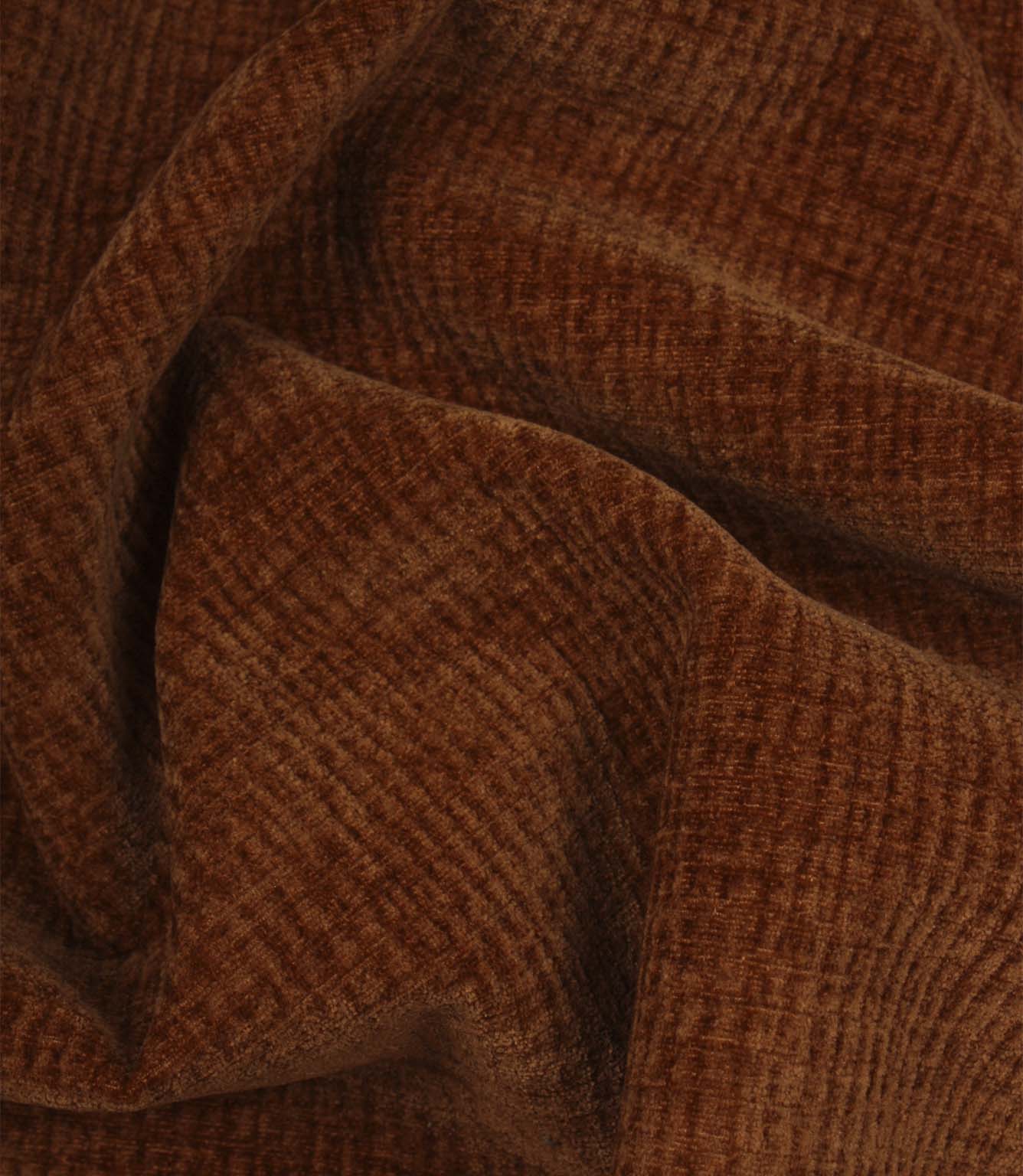 Draped Everleigh Copper upholstery fire retardant fabric featuring a luxurious velvet-look texture and elegant copper woven appearance.