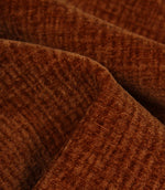 Detailed close-up of Everleigh Copper plain upholstery fabric showing the soft velour-style pile and textured copper surface.