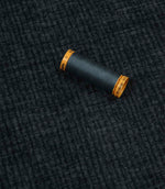 Everleigh Denim upholstery fire retardant fabric with coordinating thread, highlighting the soft-touch texture and woven plain design.