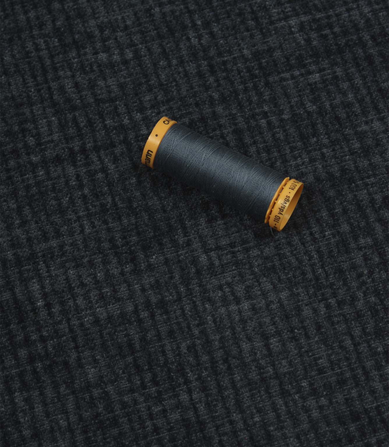 Everleigh Denim upholstery fire retardant fabric with coordinating thread, highlighting the soft-touch texture and woven plain design.