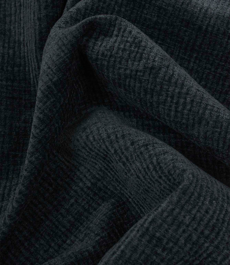 Draped Everleigh Denim upholstery fabric showing the soft handle, elegant movement and richly textured woven surface in a classic denim blue shade.