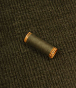 Everleigh Moss upholstery fire retardant fabric with coordinating thread, highlighting the soft-touch texture and woven plain design.