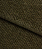 Folded Everleigh Moss plain upholstery fabric displaying its luxurious velour-inspired finish and textured moss green appearance.