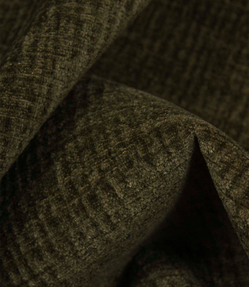 Detailed macro view of Everleigh Moss upholstery fire retardant fabric revealing the plush velour texture and subtle moss green woven pattern.