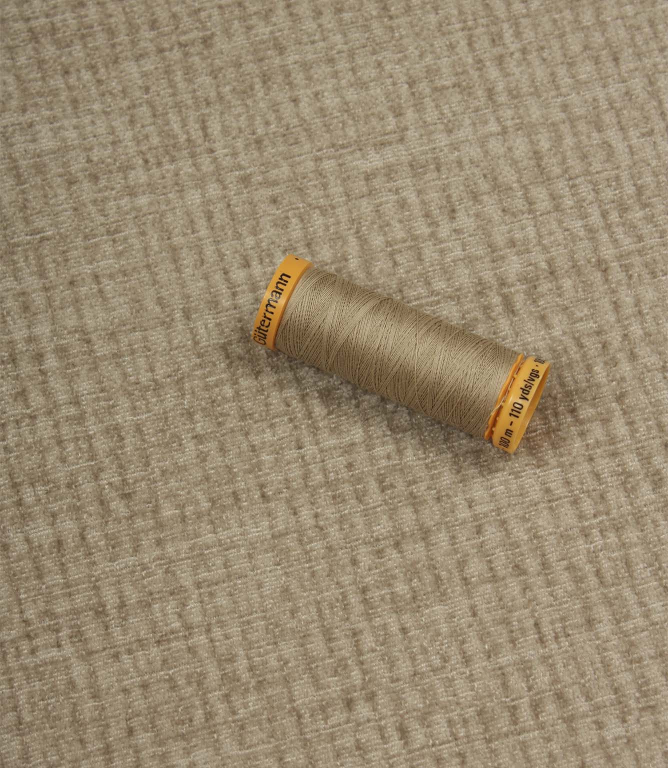 Everleigh Pebble upholstery fire retardant fabric with coordinating thread, highlighting the soft-touch texture and woven plain design.