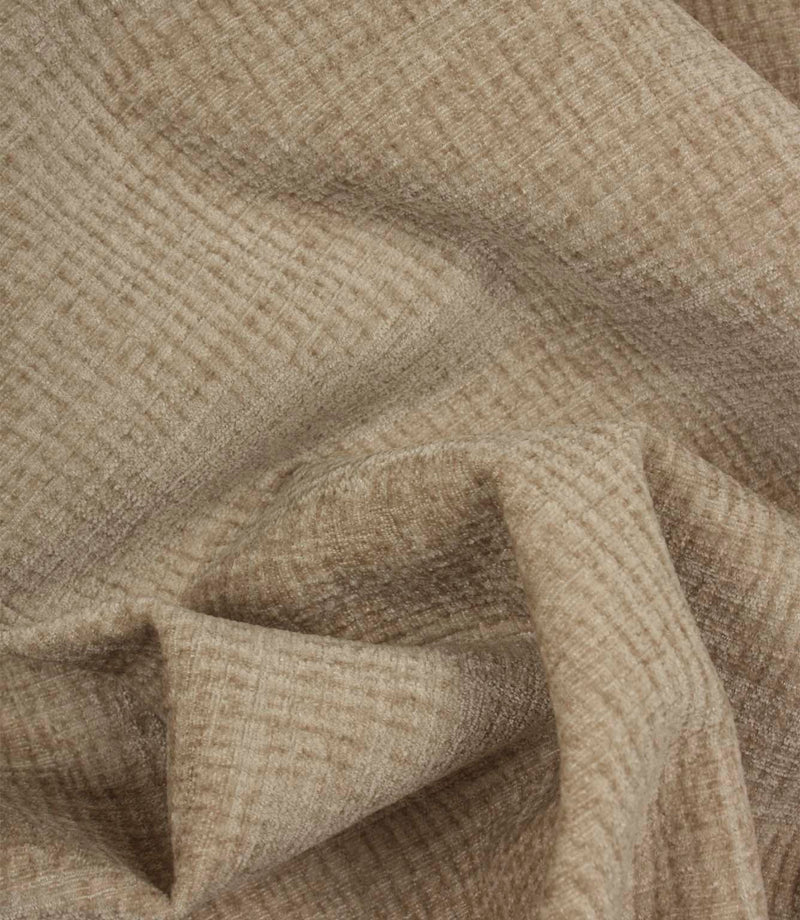 Draped Everleigh Pebble upholstery fabric showing the soft handle, elegant movement and richly textured woven surface.
