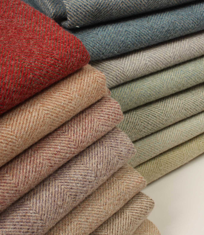 Stack of folded herringbone fabric in various colours