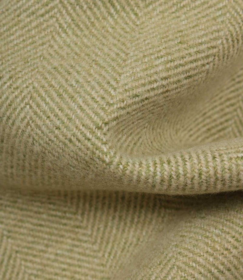 Close-up of green fabric with a herringbone pattern