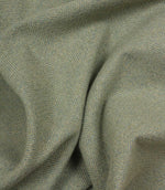 Close-up of green and blue fabric with a herringbone pattern
