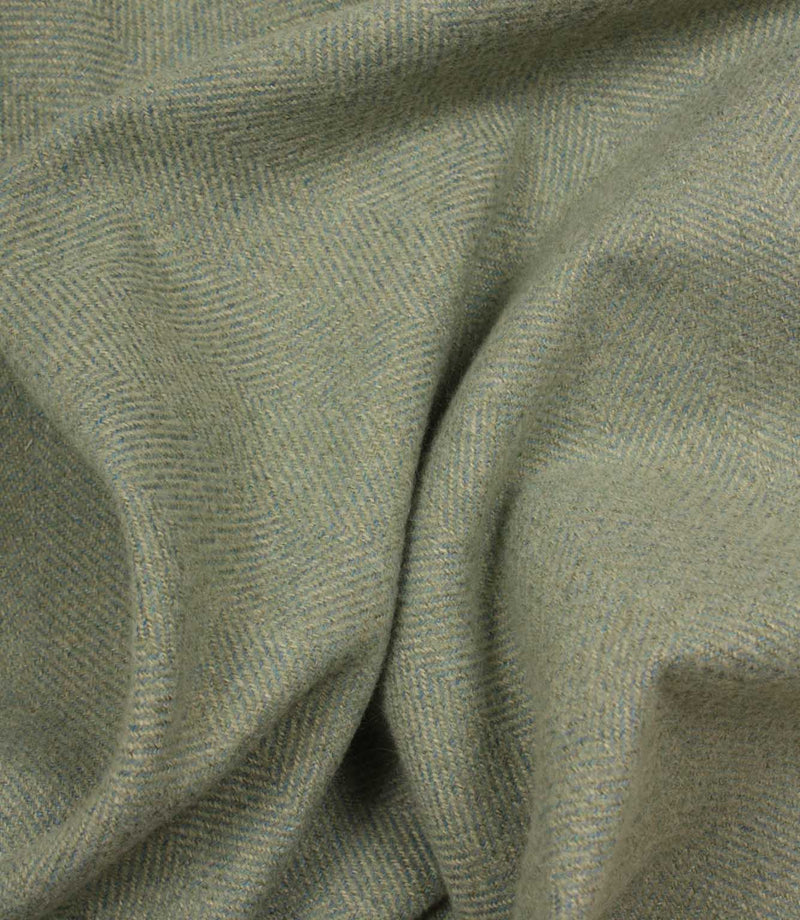 Close-up of green and blue fabric with a herringbone pattern