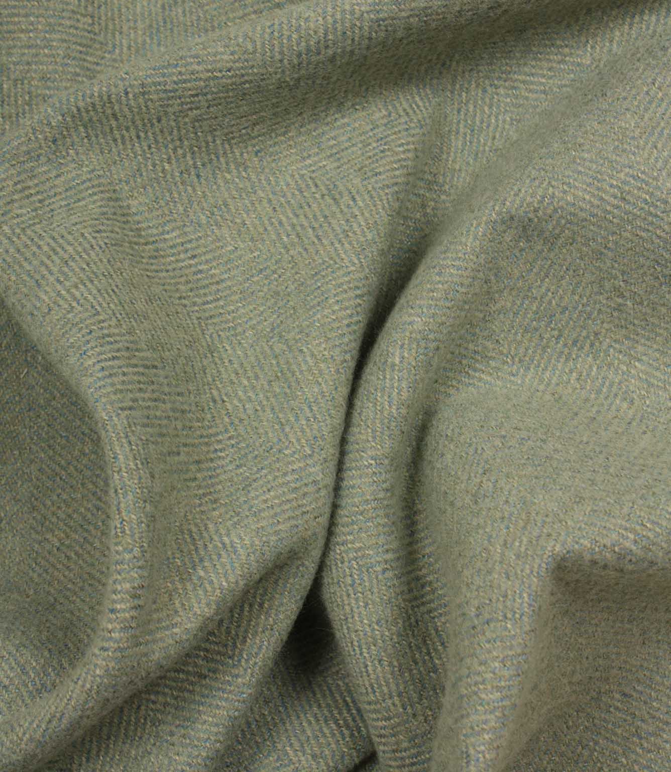 Close-up of green and blue fabric with a herringbone pattern