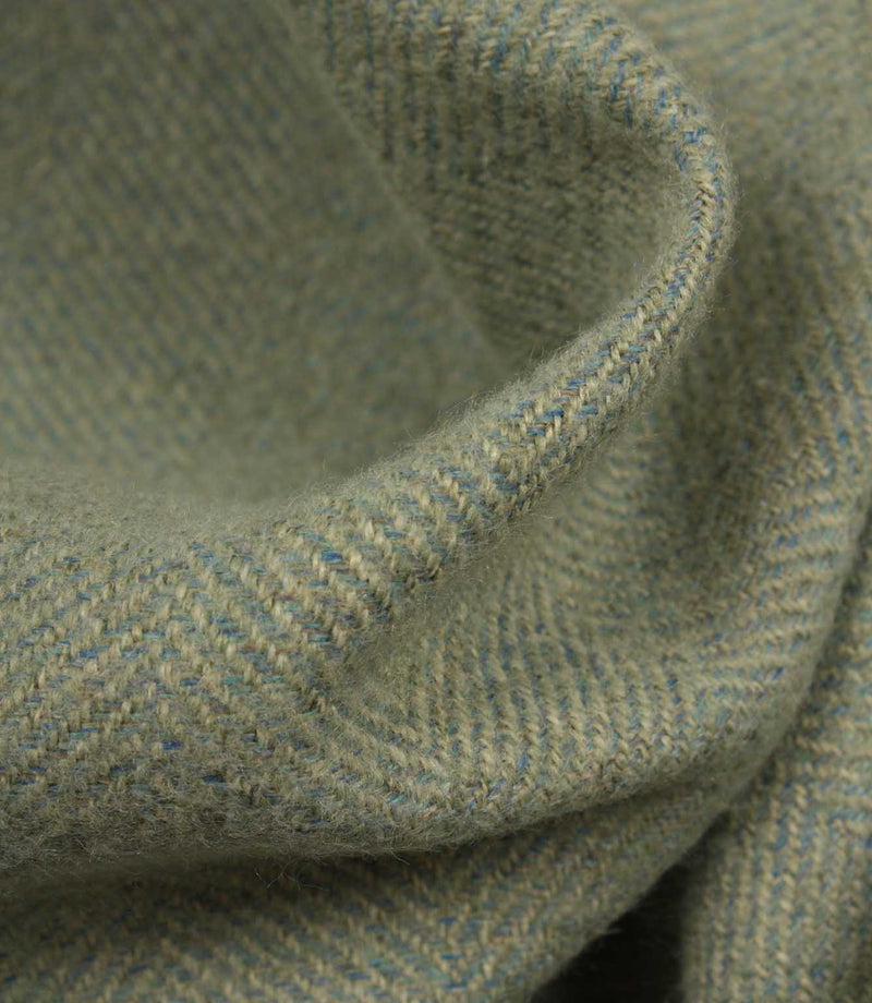 Close-up of textured blue and green fabric with a subtle pattern