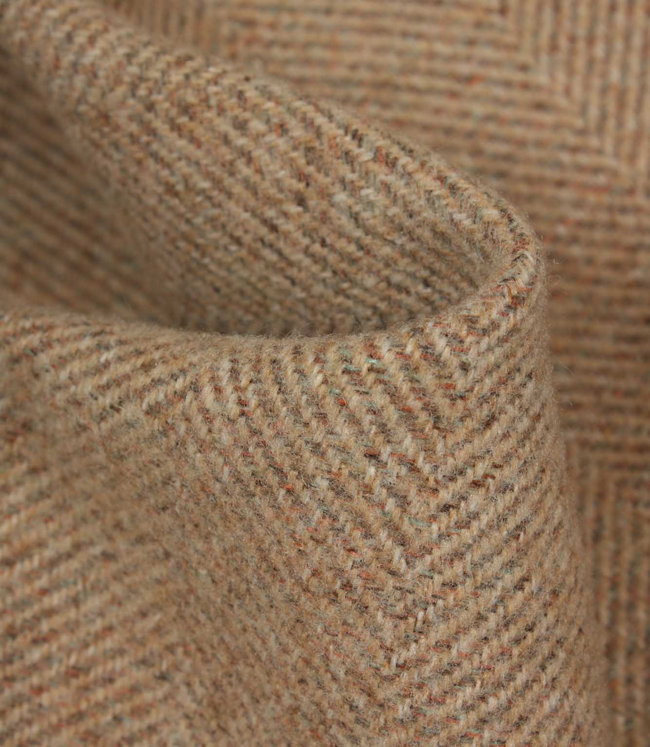 Close-up of textured blush and brown fabric with a herringbone pattern